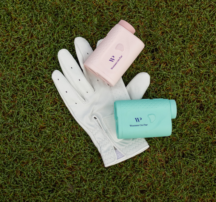 White golf glove with pink and green women on par rangefinders on grass